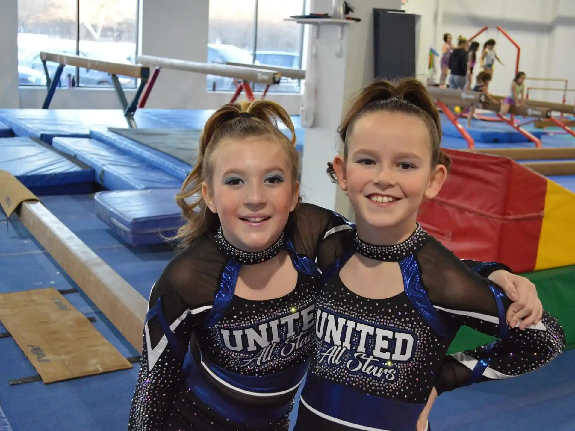 a couple of girls posing for the camera