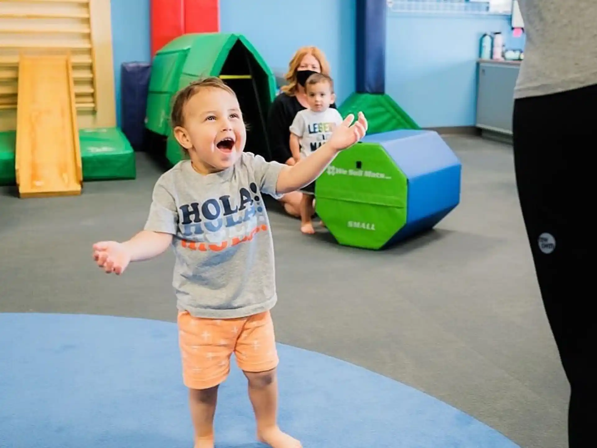 a child running on a blue mat