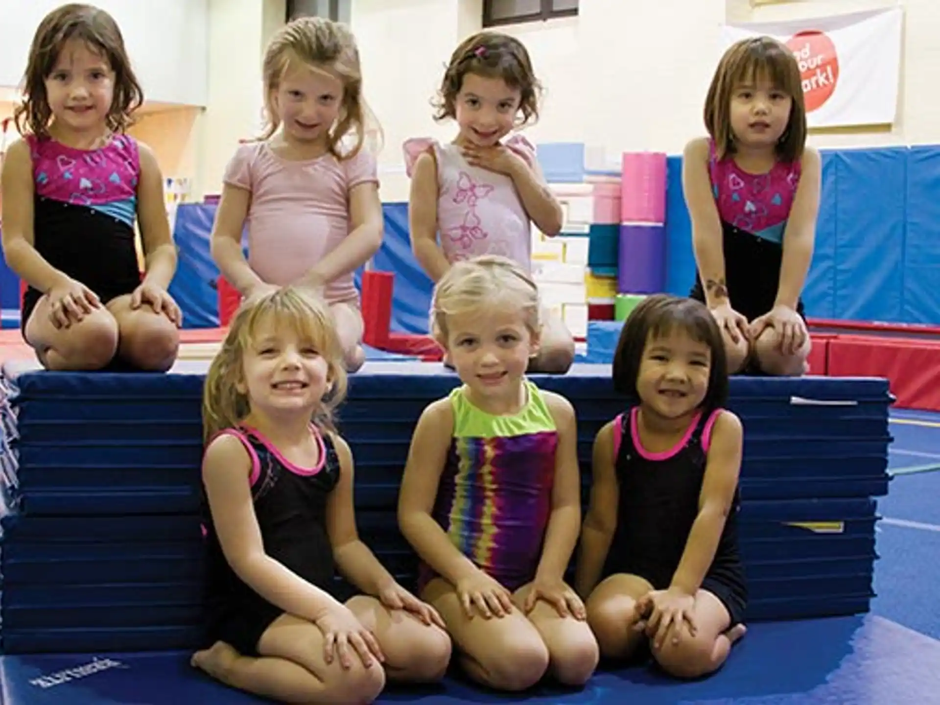 a group of children sitting on a mat