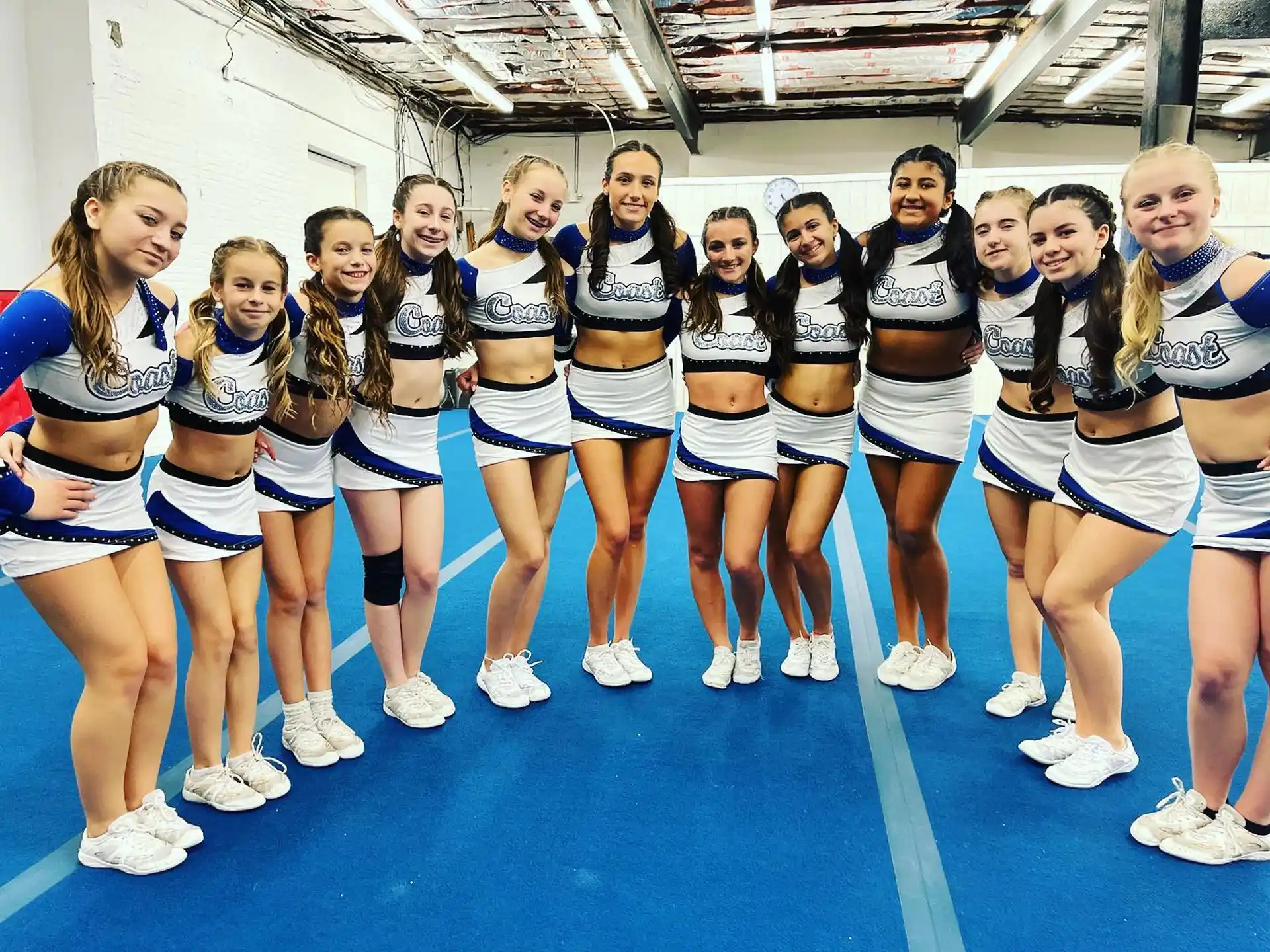 a group of cheerleaders posing for a photo