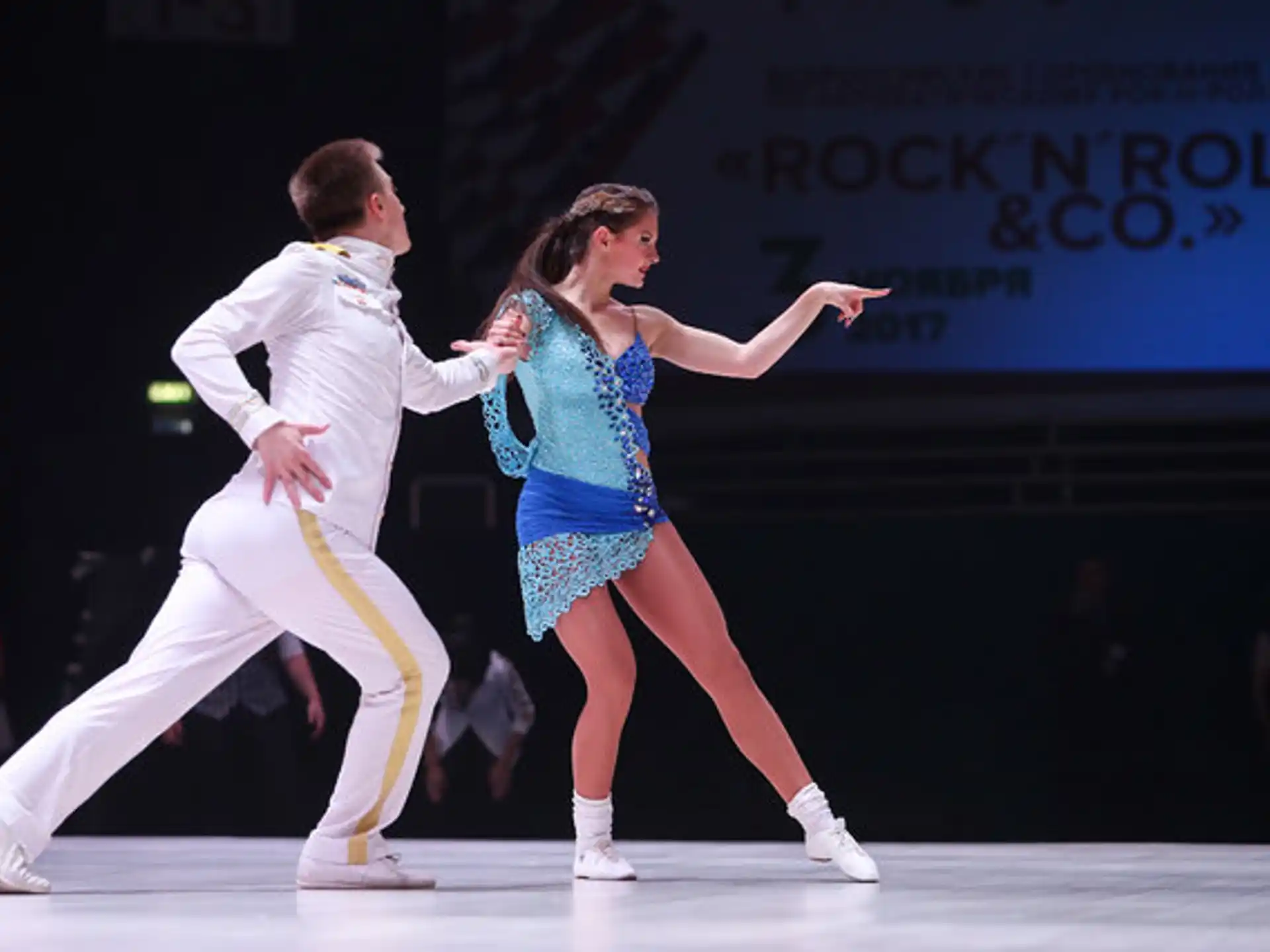a man and woman dancing on a stage