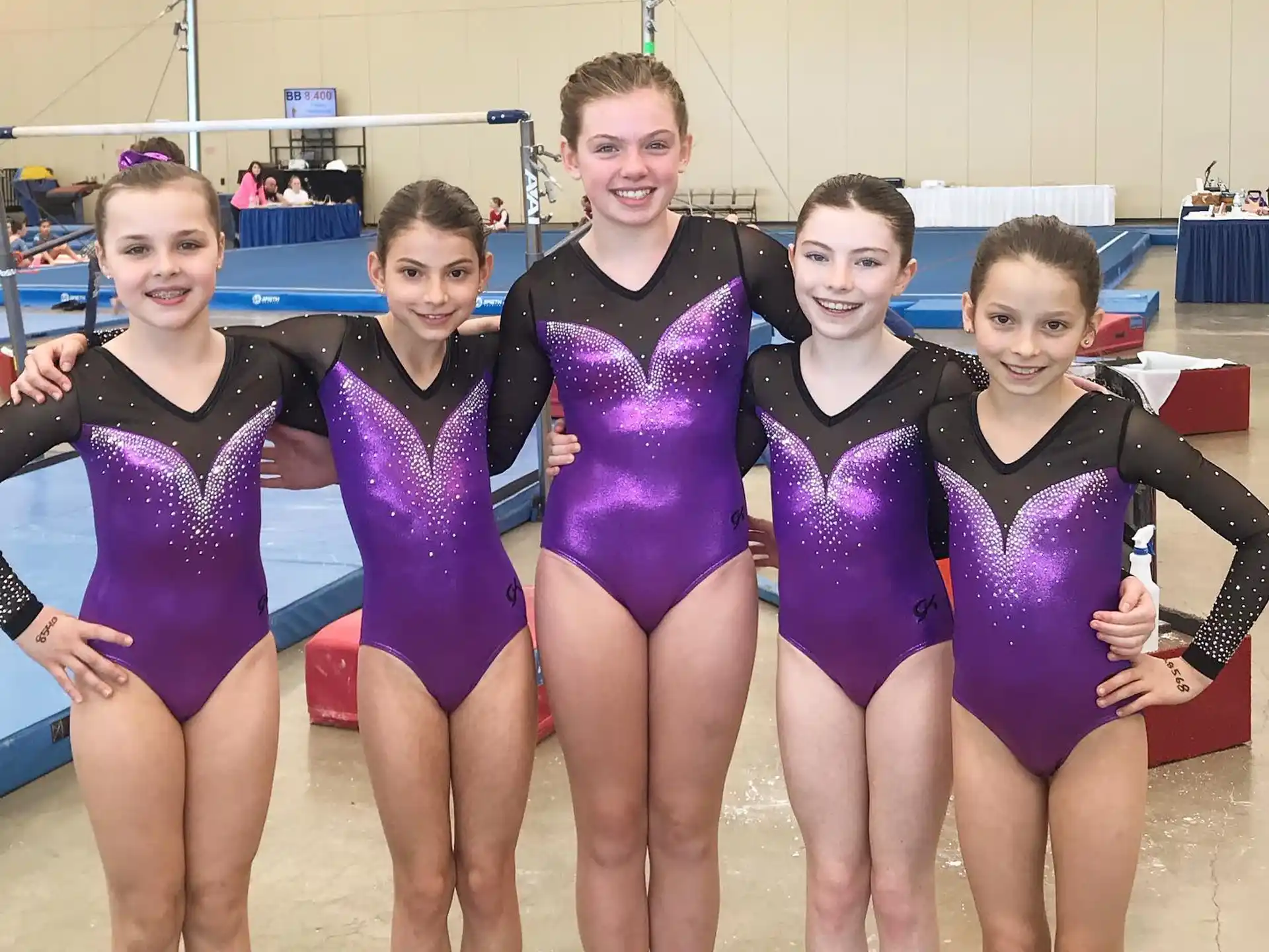 a group of women in swimsuits posing for a photo