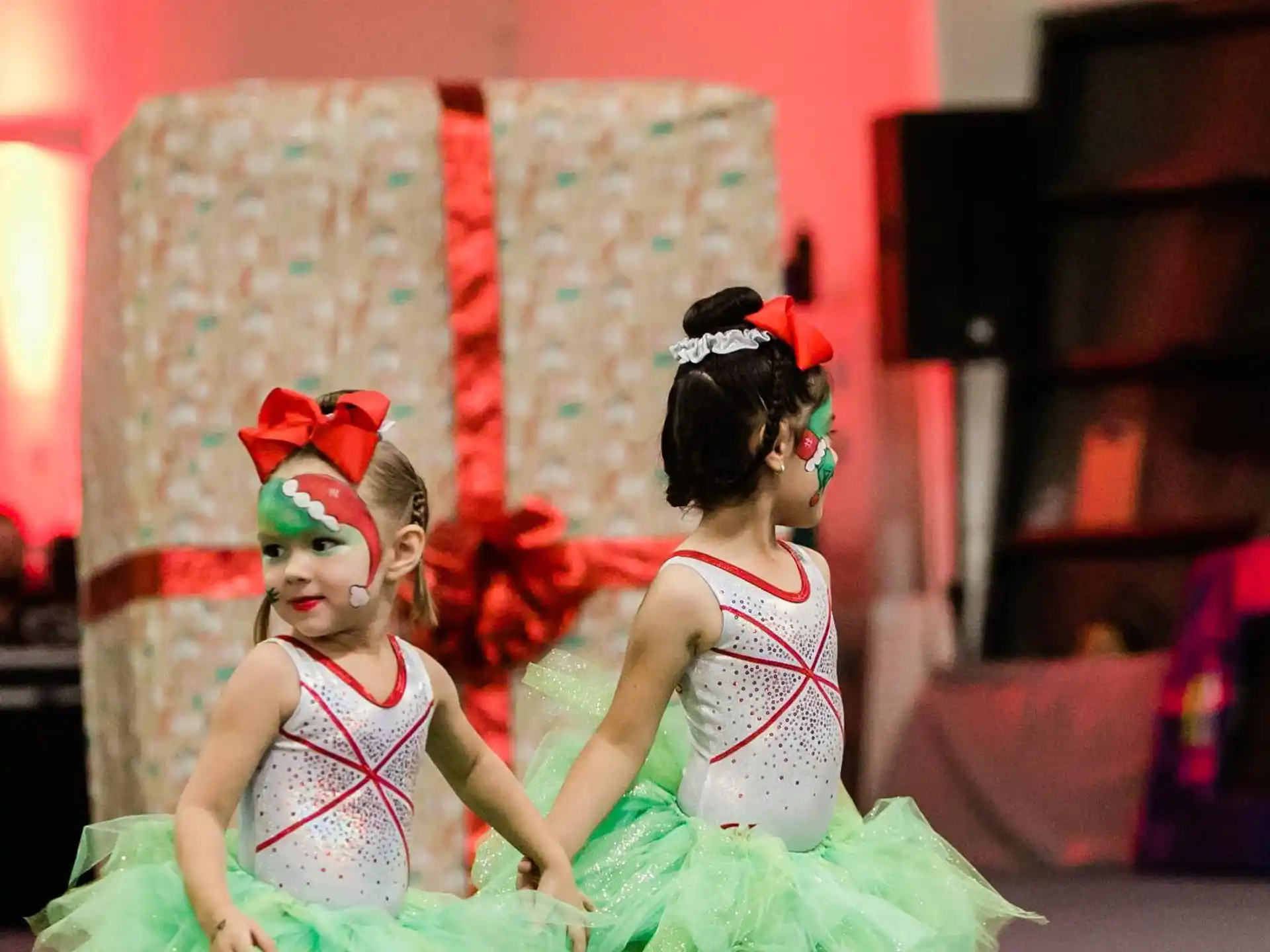 a couple of girls wearing dresses and dancing
