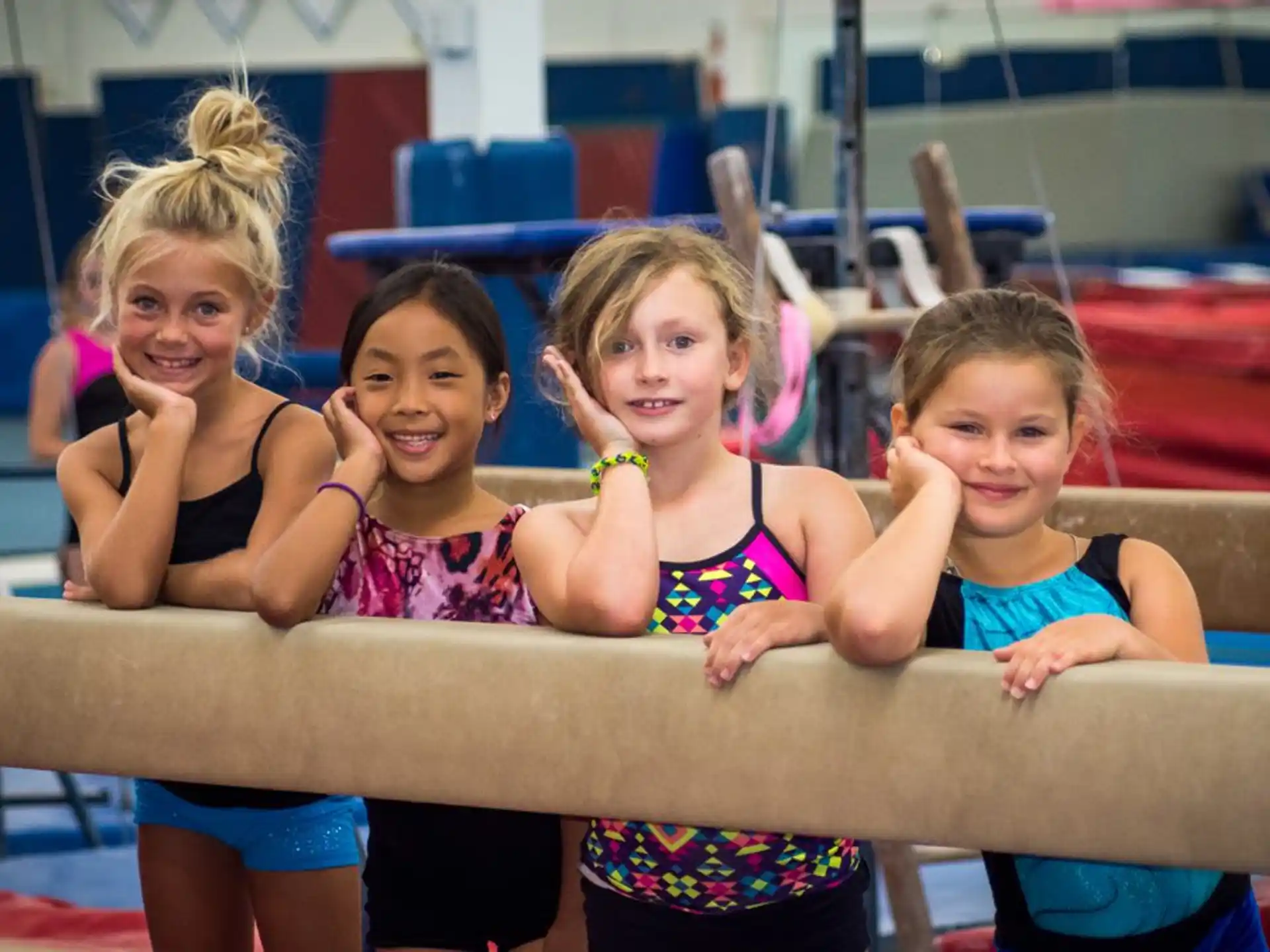 a group of girls in swimsuits posing for a photo