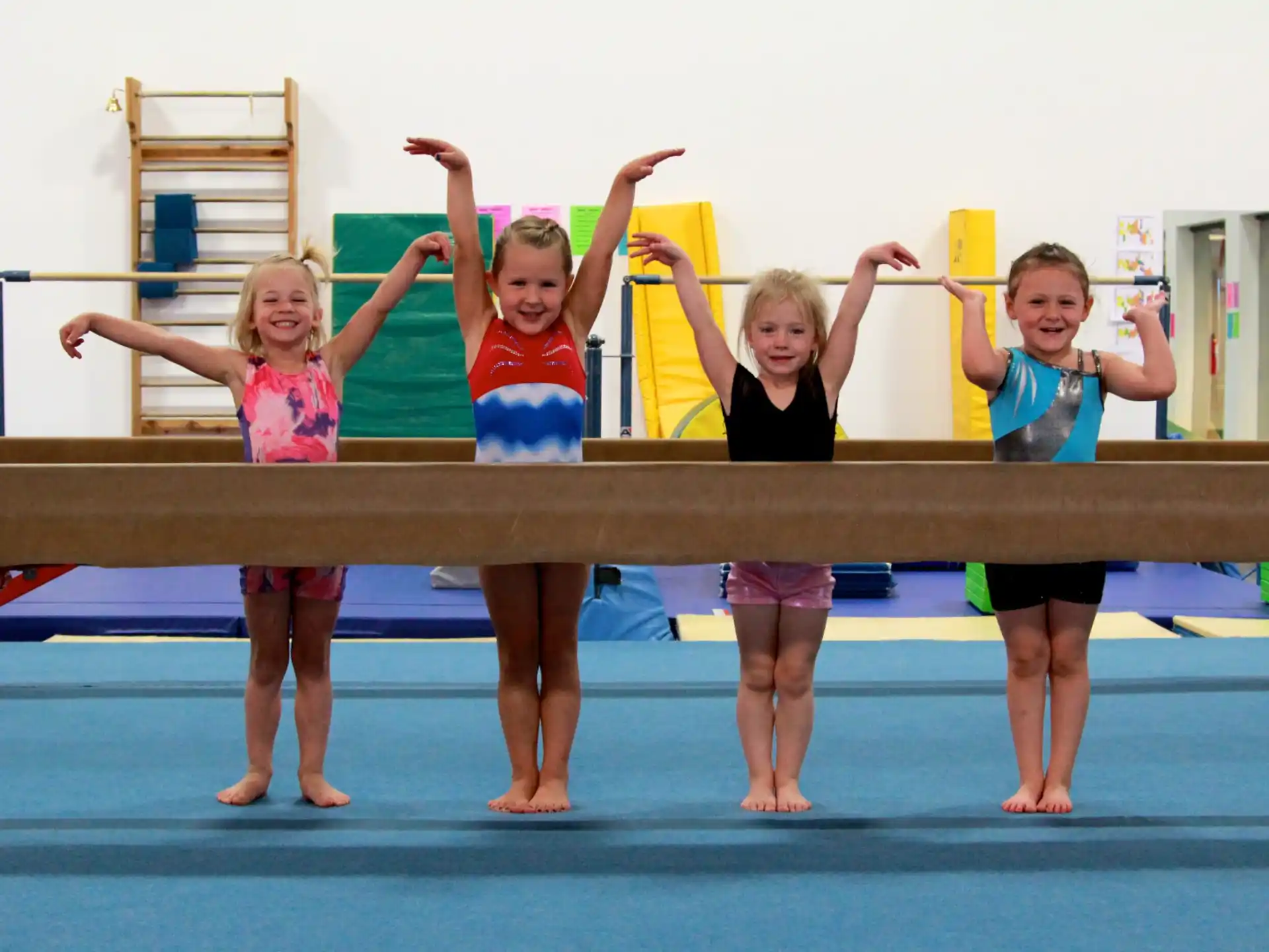 a group of girls posing for a photo on a trampoline