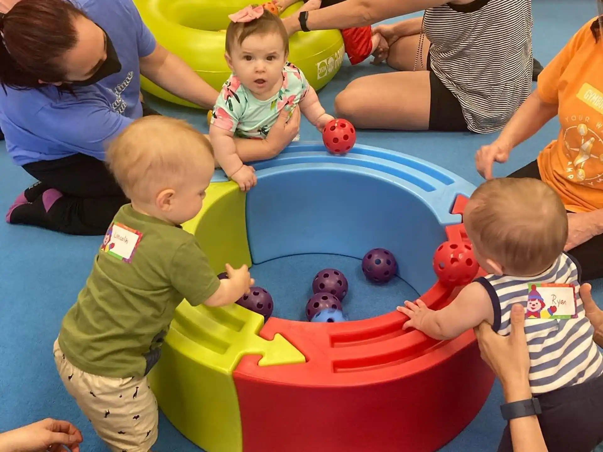 a group of children playing in a pool