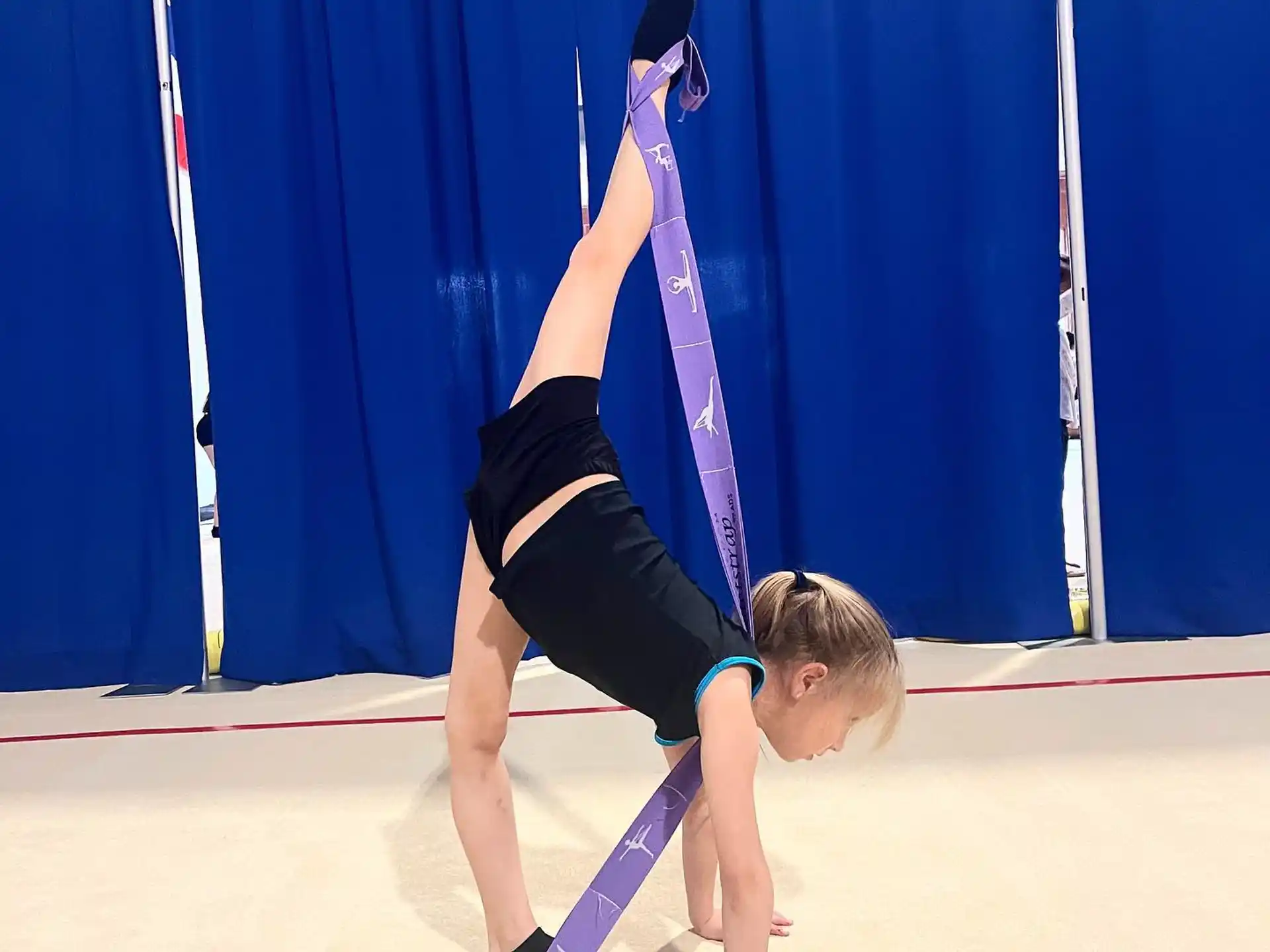 a person doing a handstand on a mat