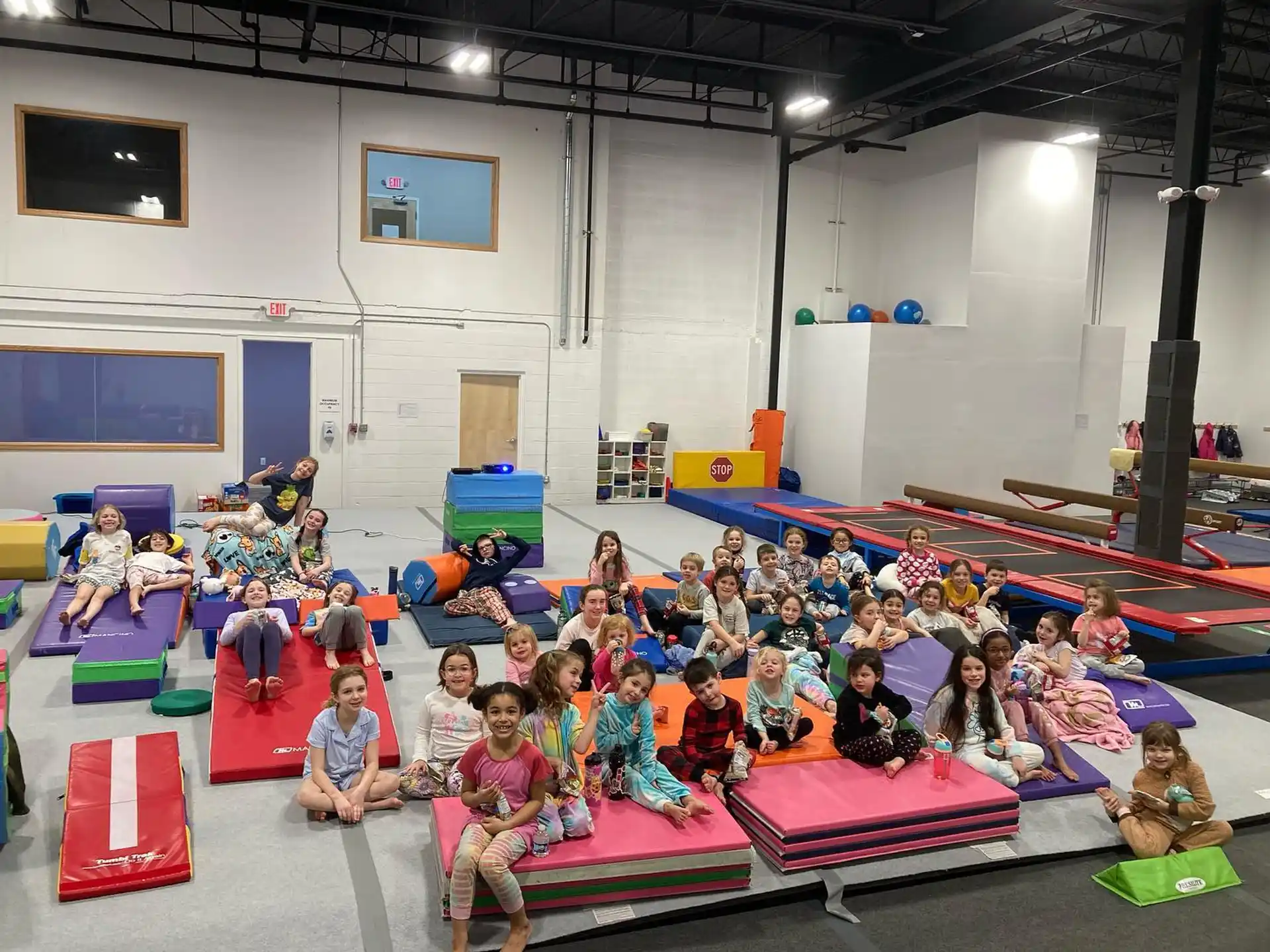 a group of children sitting on mats
