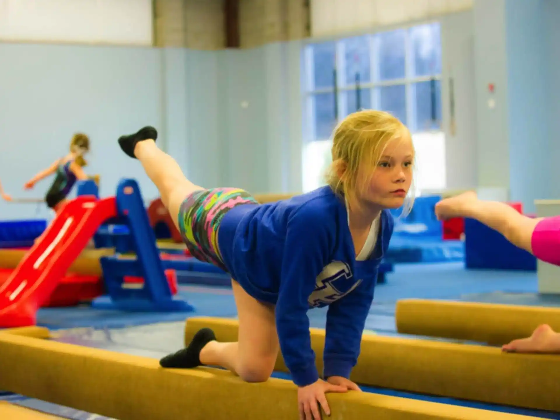 a girl doing a plank on a bench
