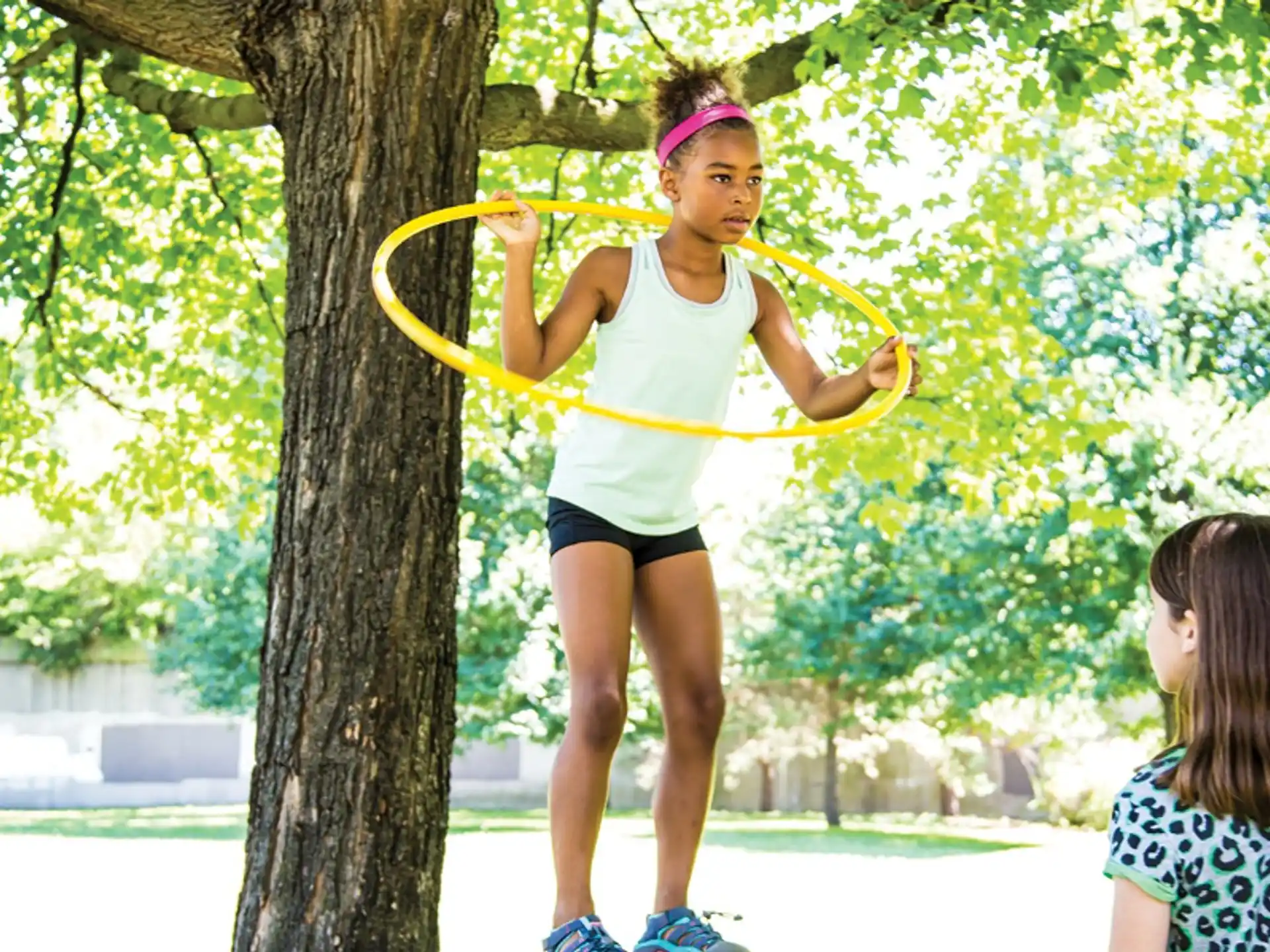 a girl holding a yellow hoop