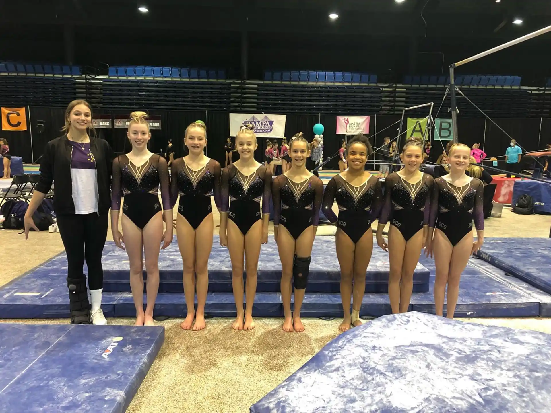 a group of women in swimsuits standing on a pool