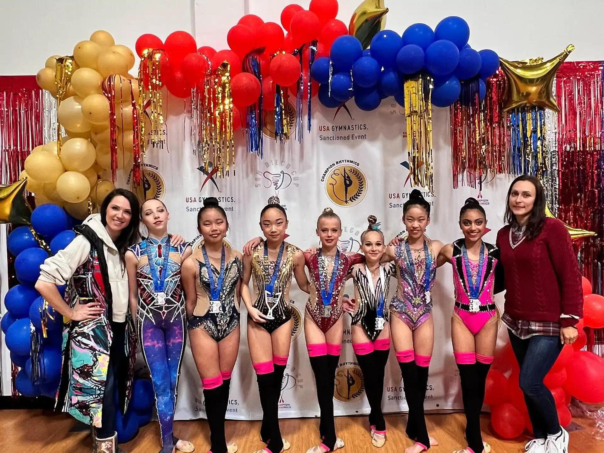 a group of people posing for a photo with balloons
