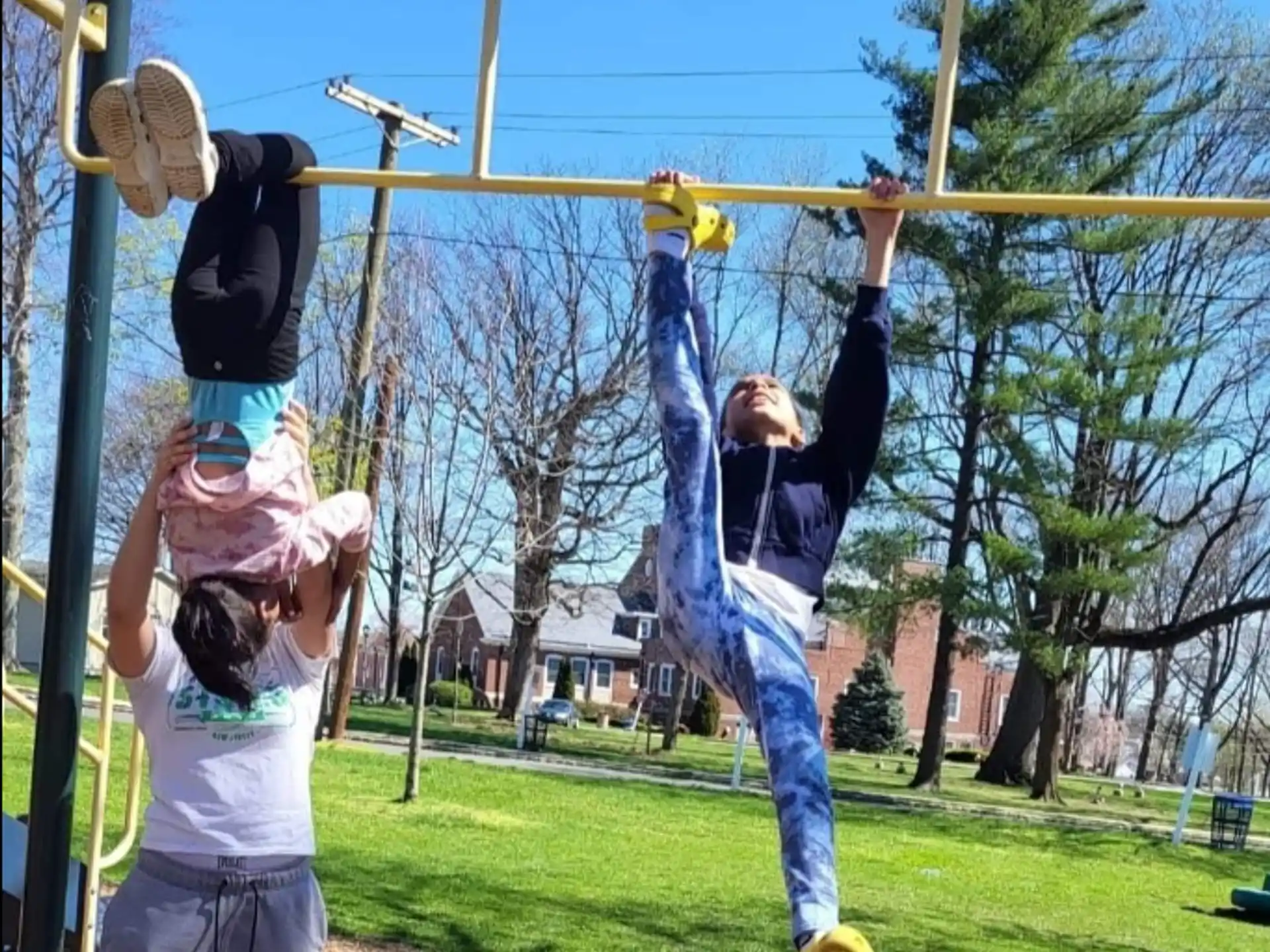 a group of kids playing on a swing set