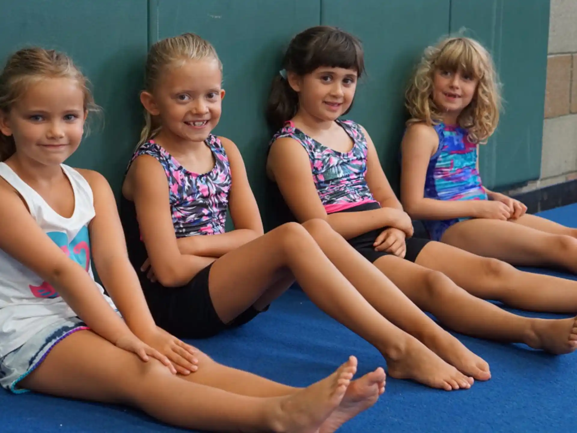 a group of girls sitting on the floor