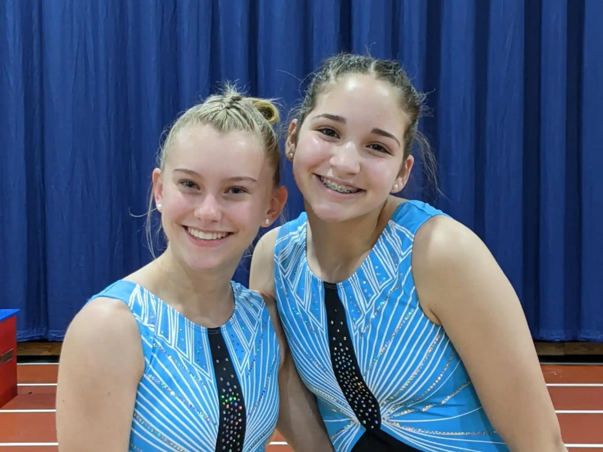 two women wearing black and blue uniforms