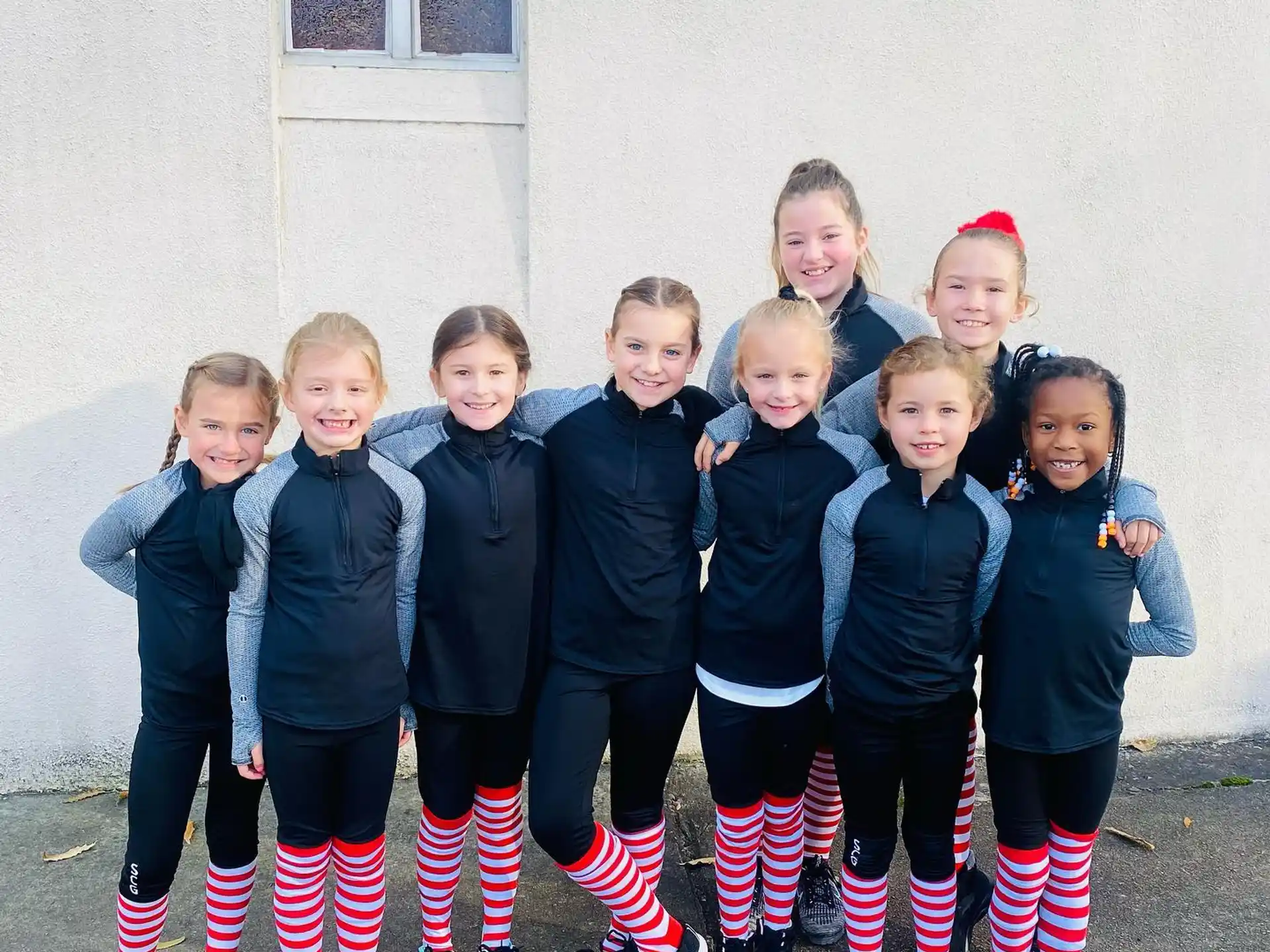 a group of children in black and white uniforms