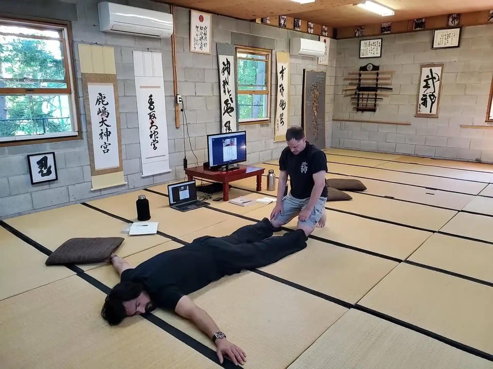 a man lying on the floor with a woman standing behind him