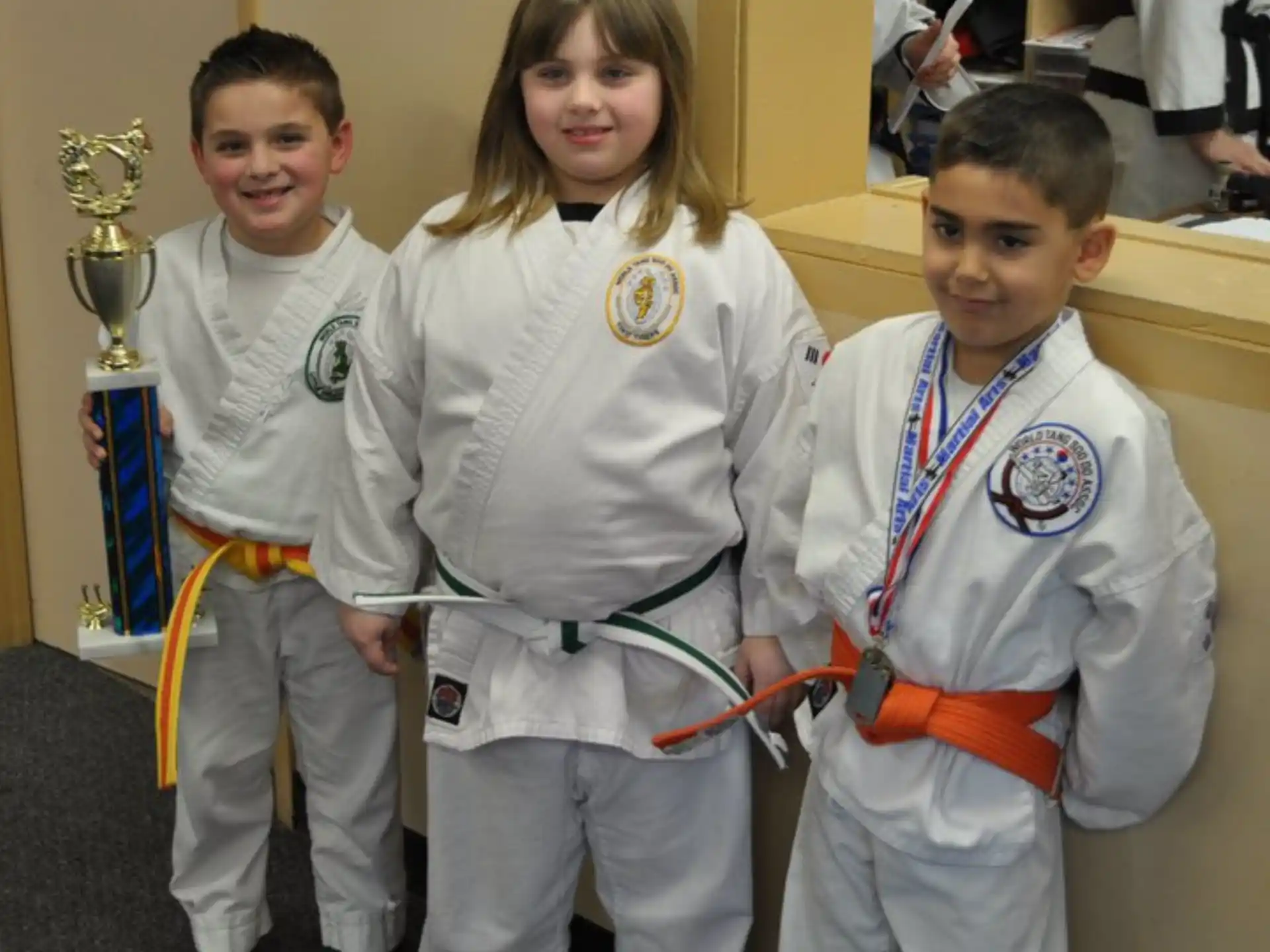 a group of children in karate uniforms