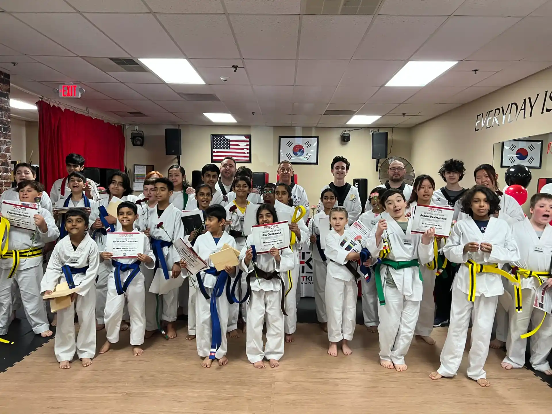 a group of children in karate uniforms