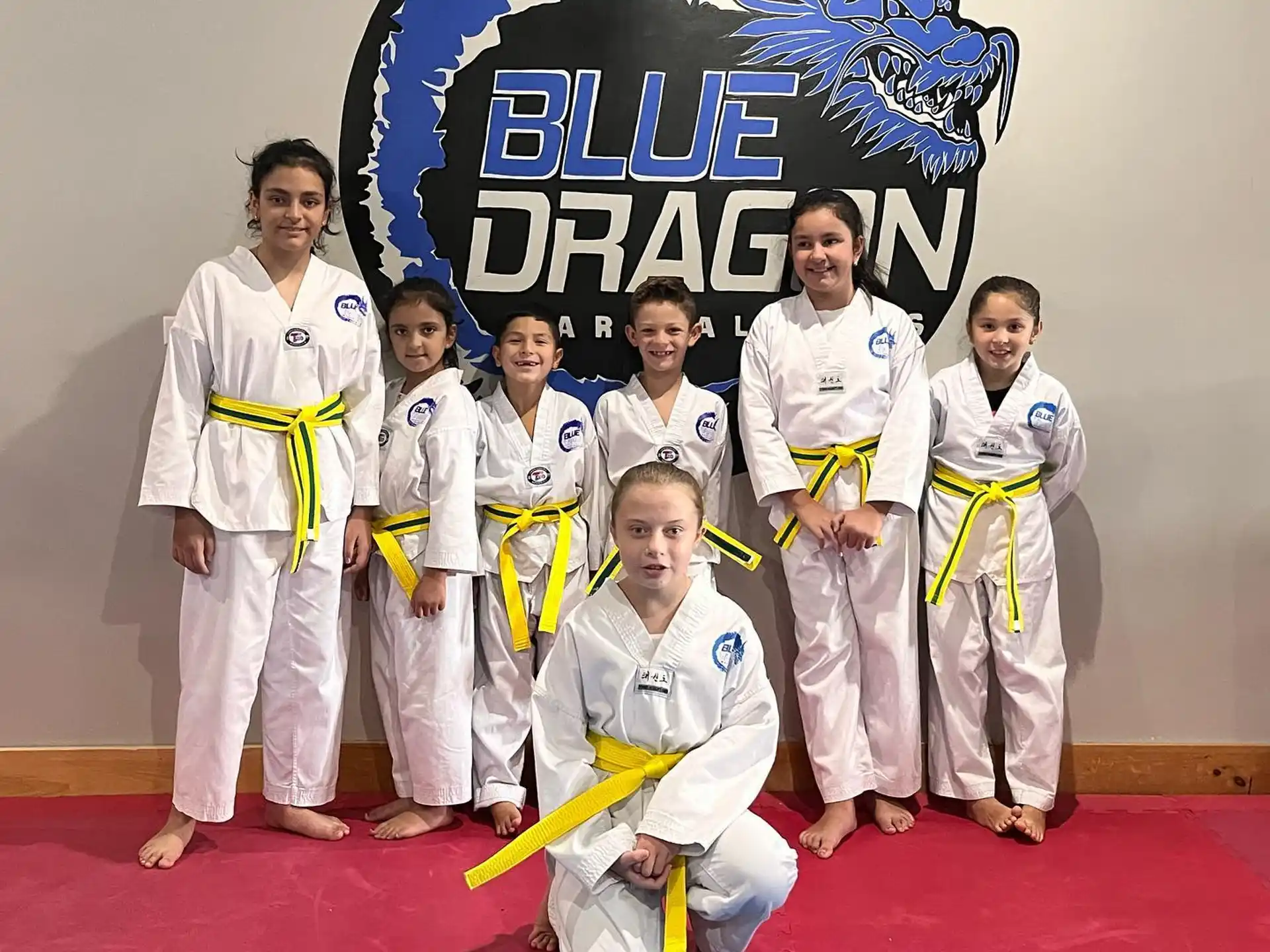 a group of people in karate uniforms