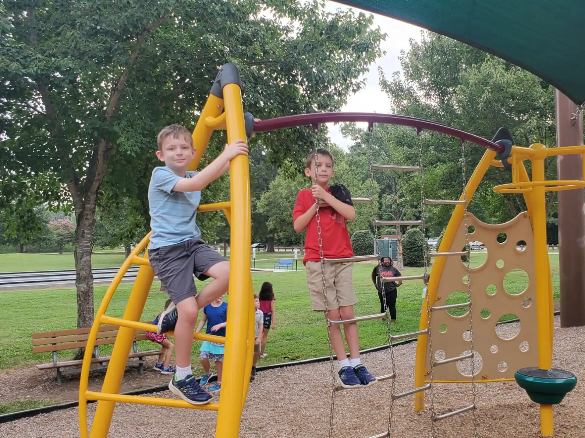 a couple of boys playing on a playground
