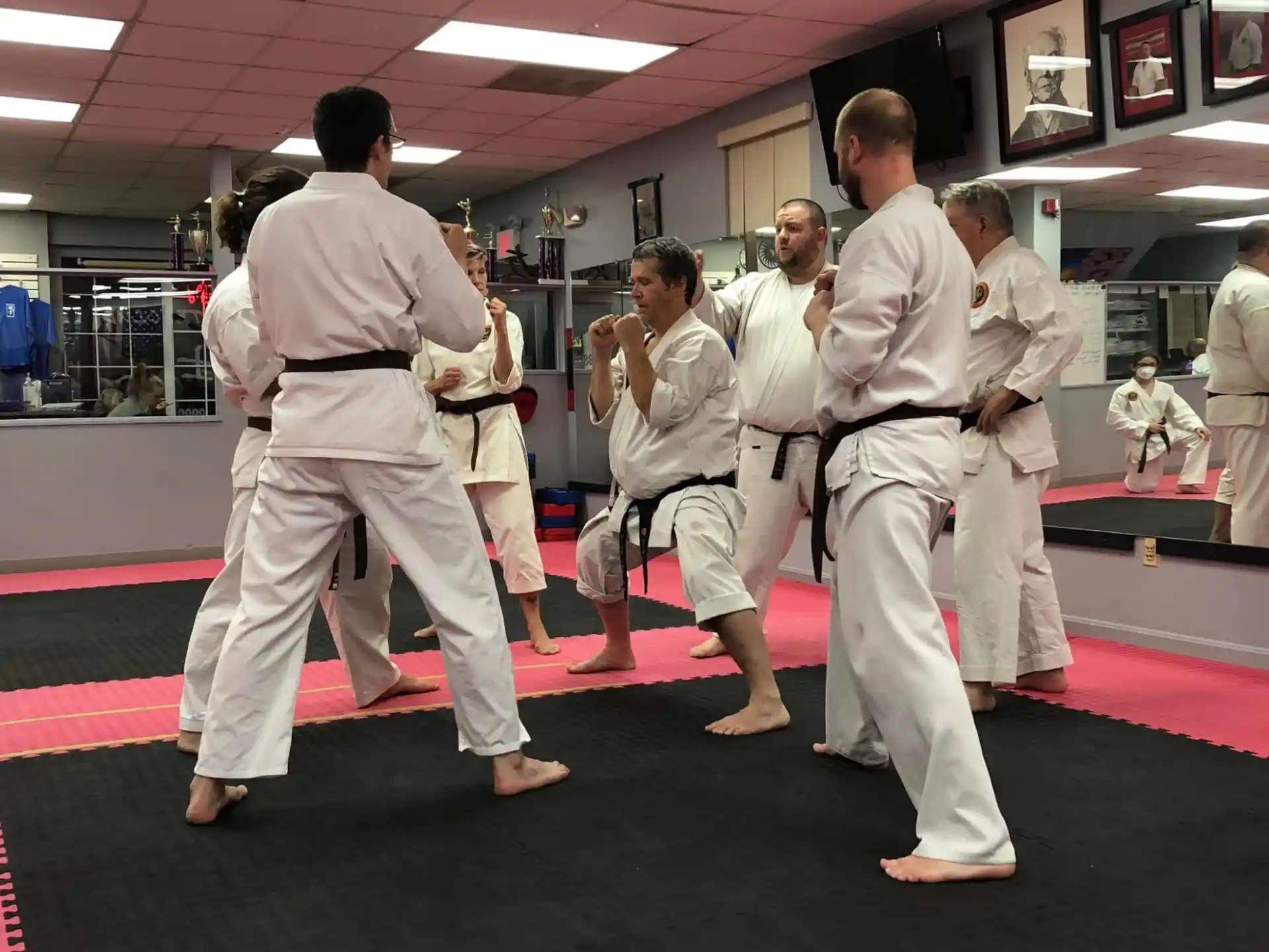 a group of people in white karate uniforms