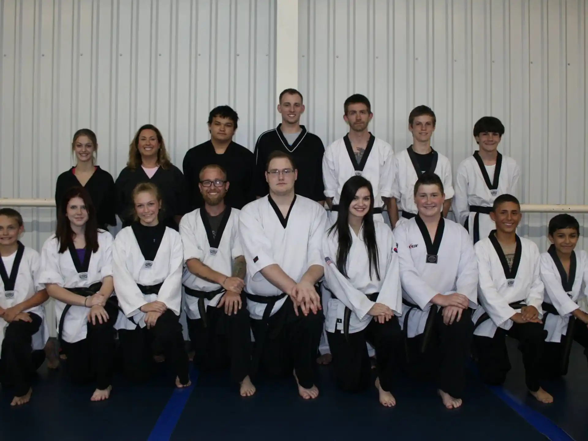 a group of people wearing white shirts and black suspenders
