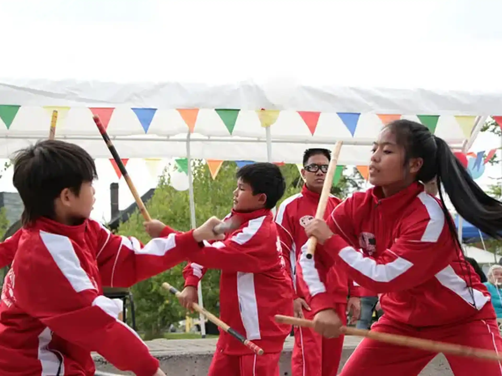 a group of people in red uniforms holding swords