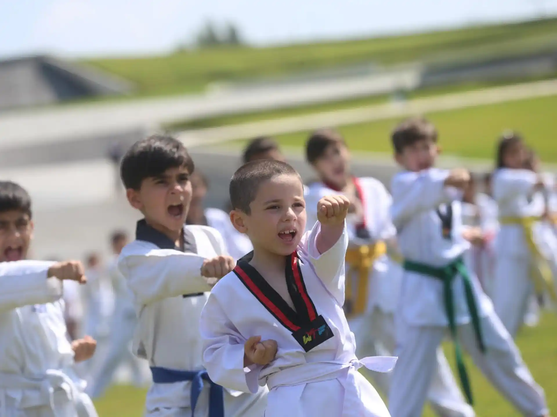 a group of children in white karate uniforms