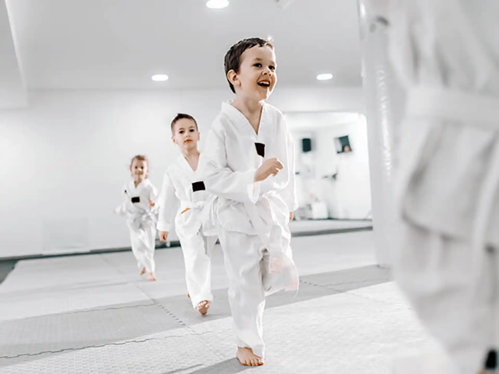 a group of people in white karate uniforms
