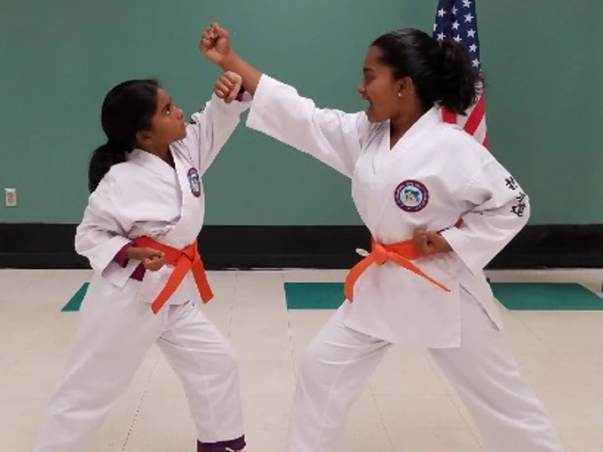 a couple of women in karate uniforms