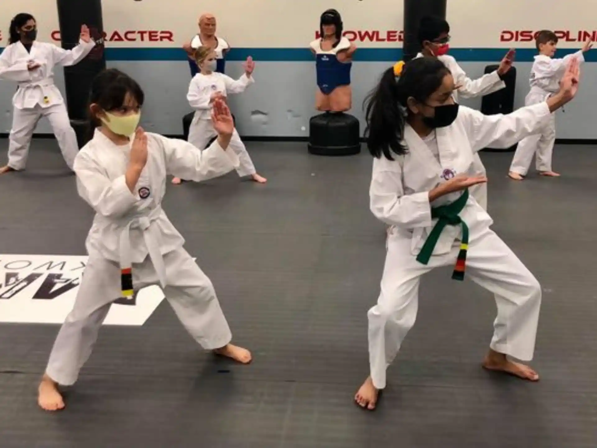 a group of people in white karate uniforms