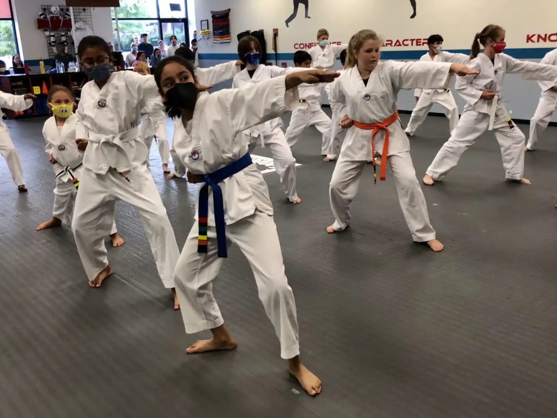 a group of people in white karate uniforms