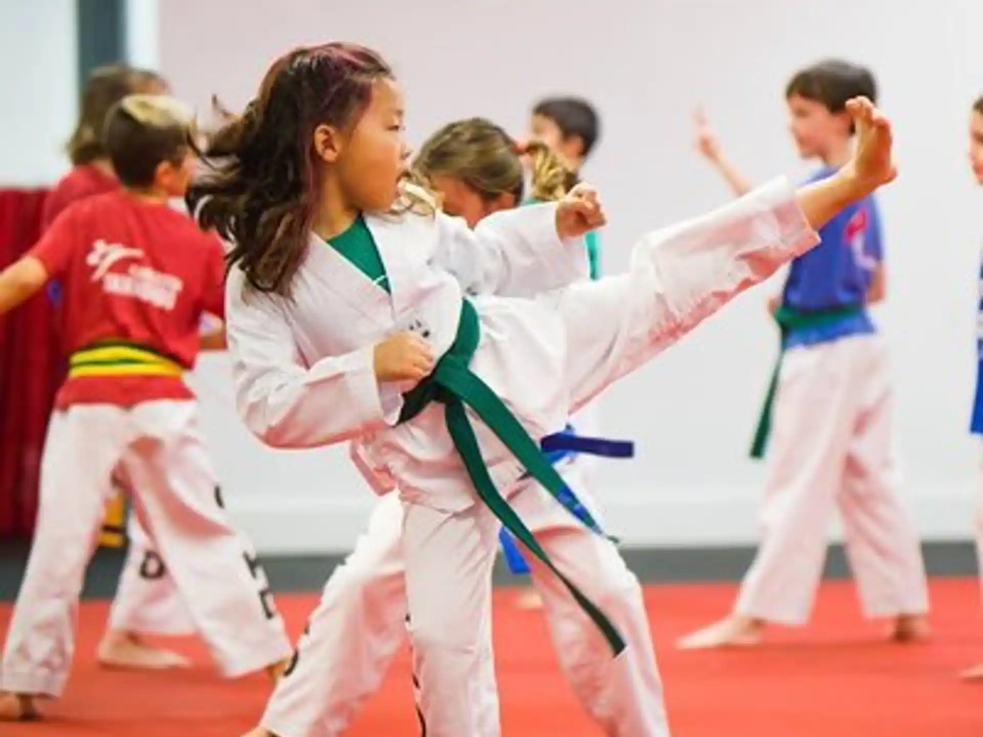 a group of children in karate uniforms