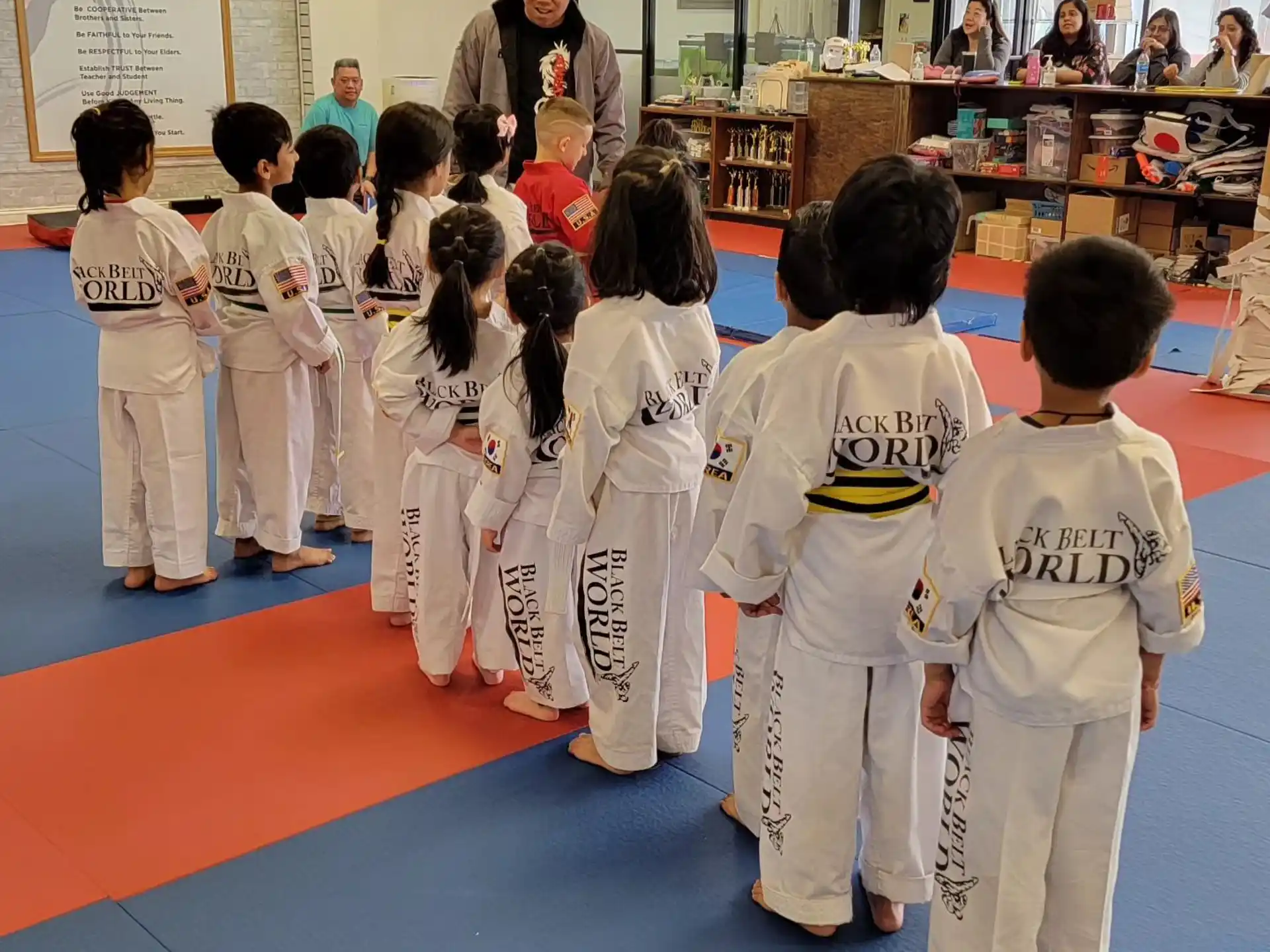 a group of children in karate uniforms