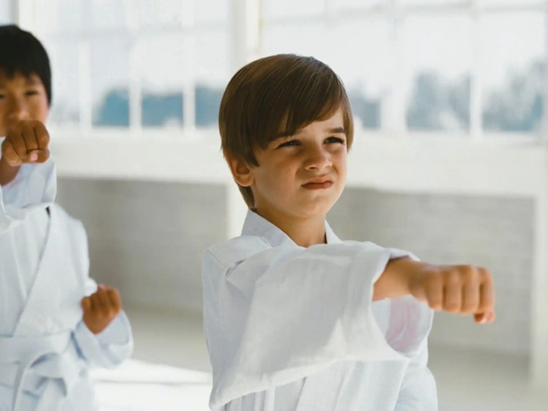 a couple of people in white karate uniforms