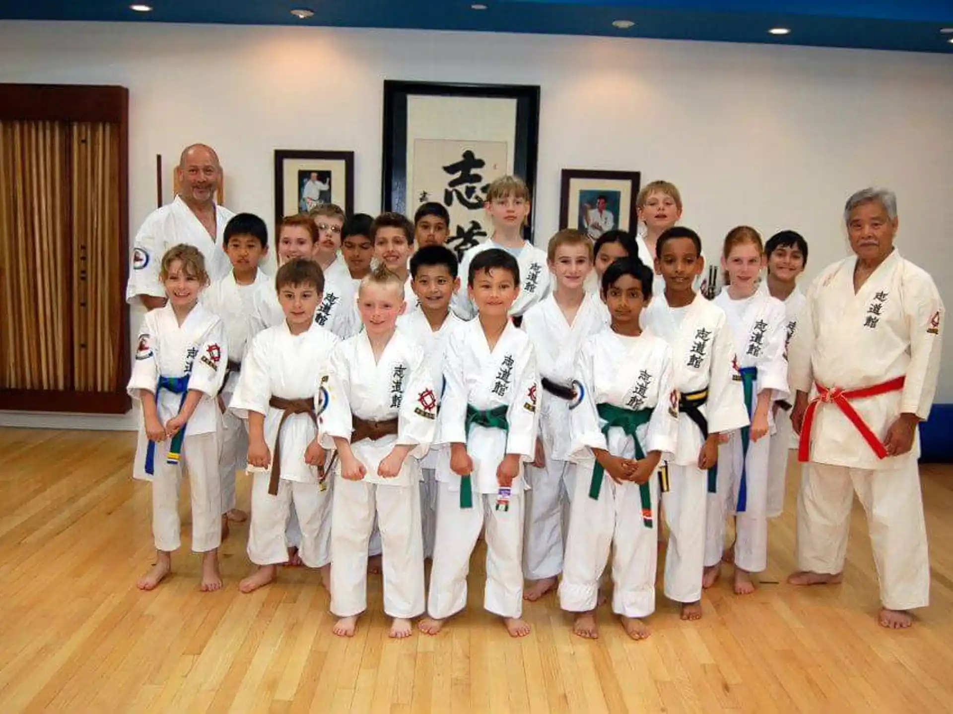 a group of people in white karate uniforms