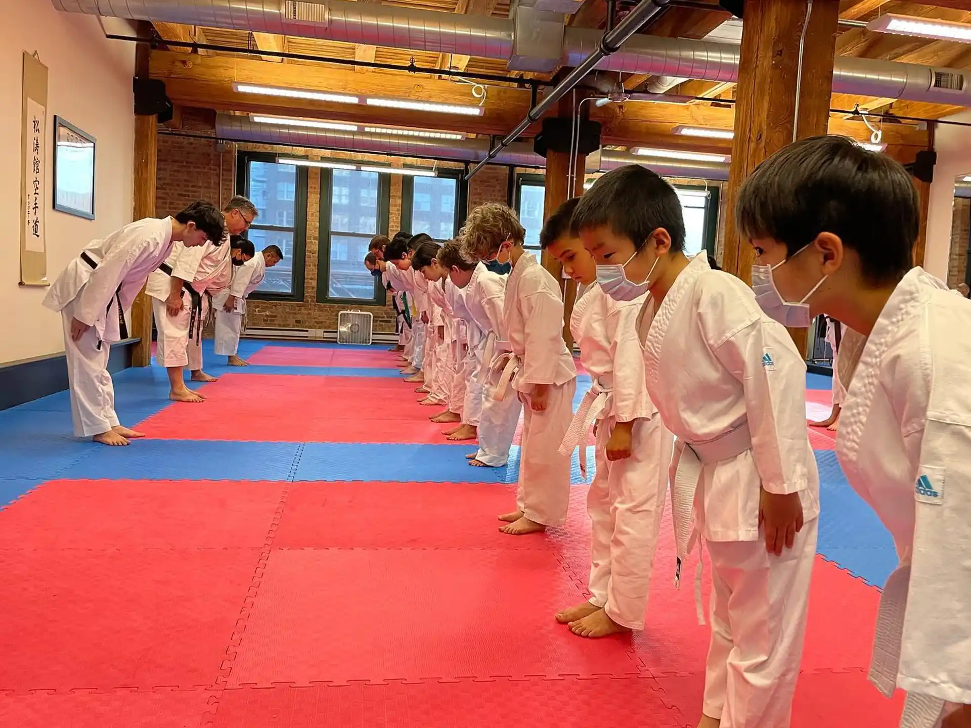 a group of people in white karate uniforms
