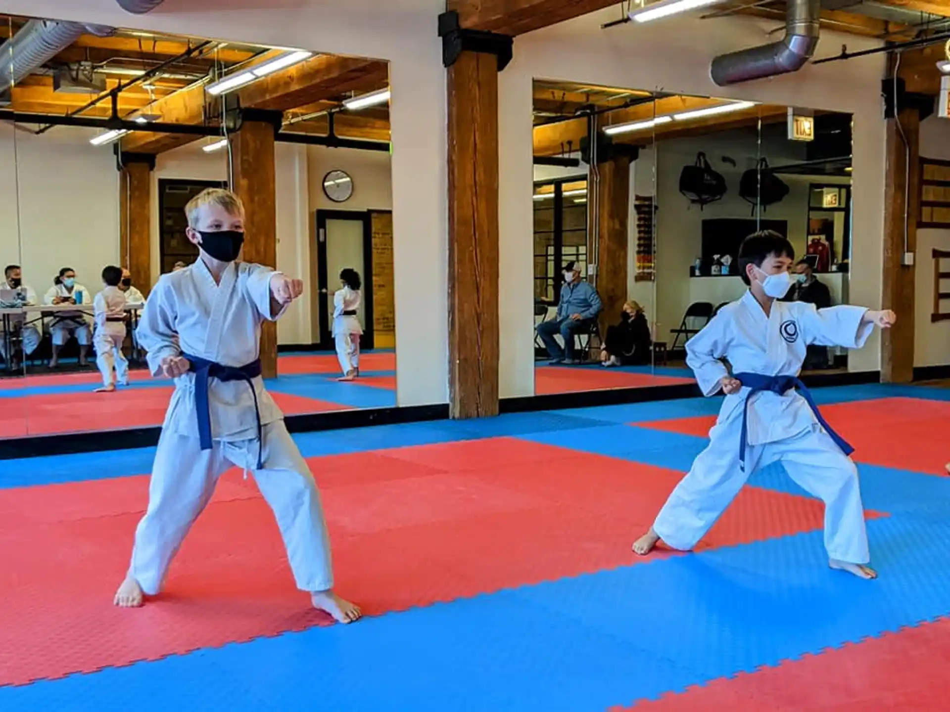 two people in white karate uniforms
