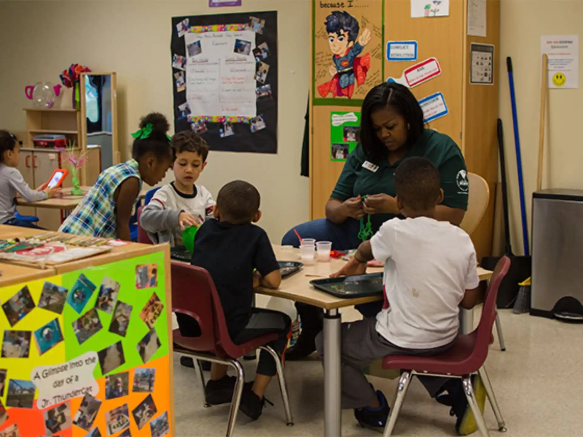 a group of children sitting around a table