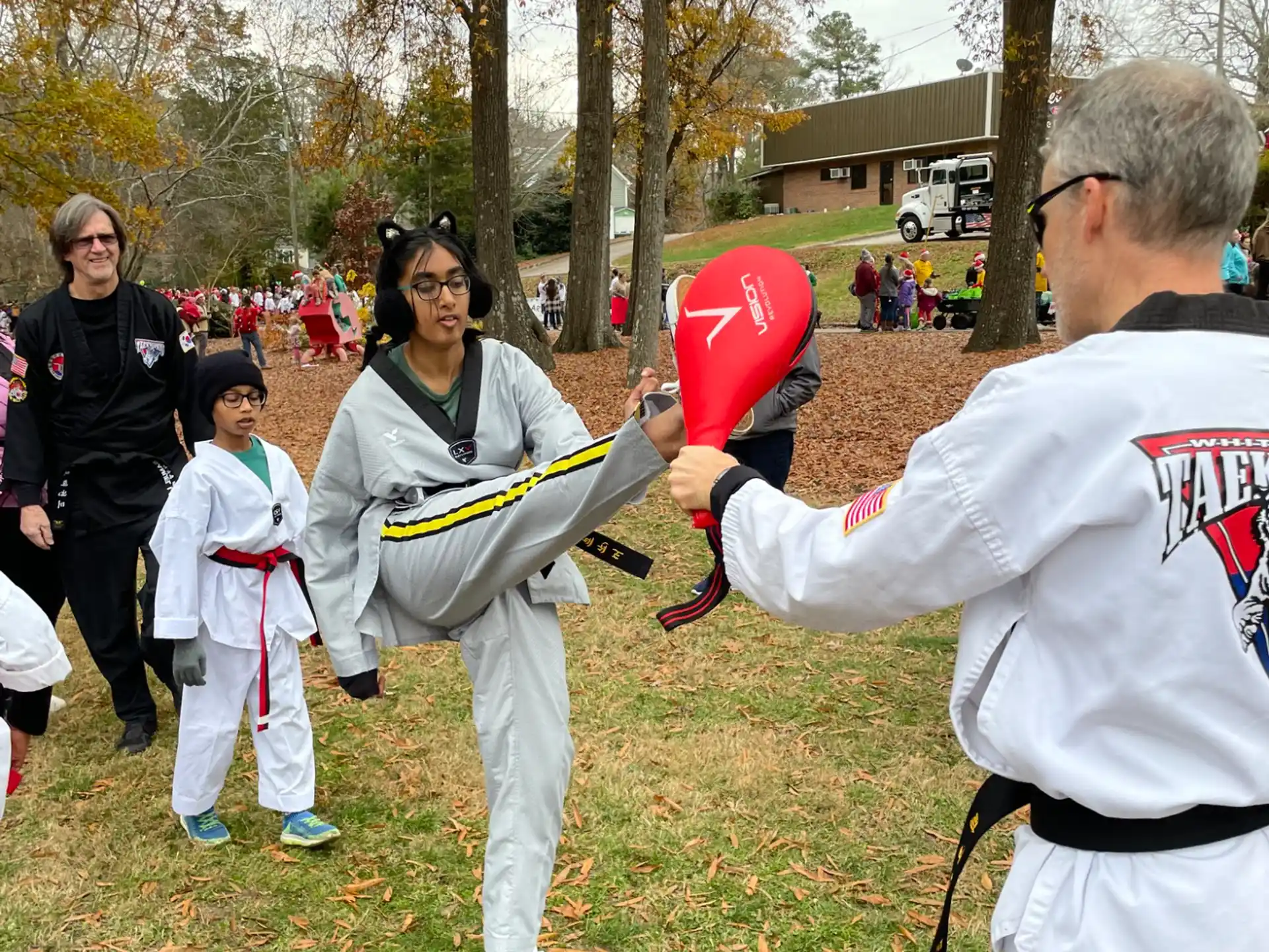 a man holding a red object in front of a group of people