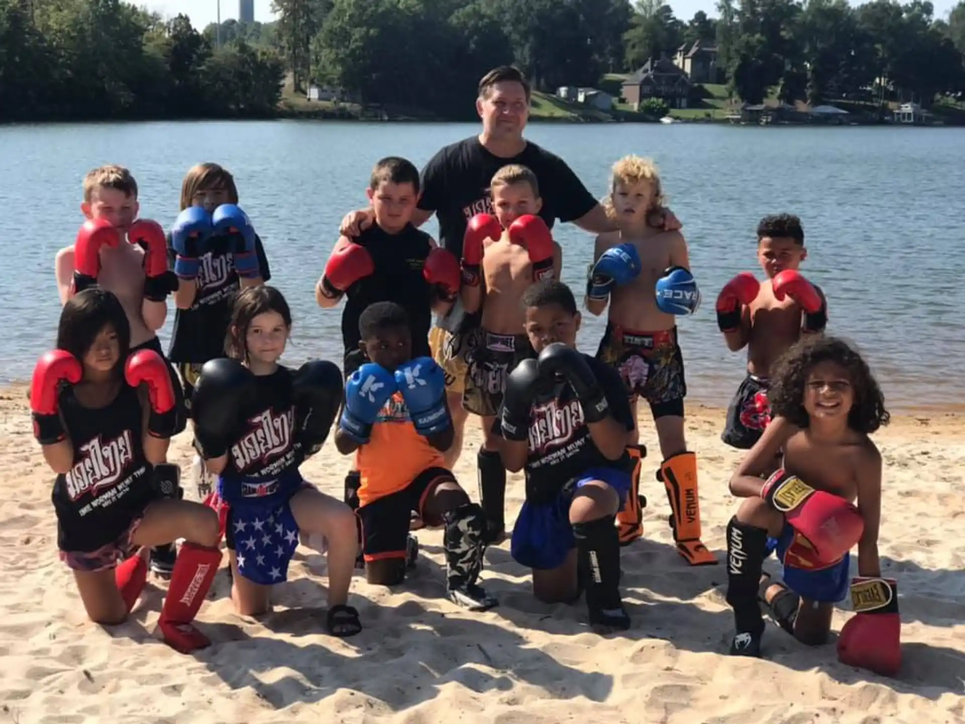 a group of kids posing for a photo on a beach
