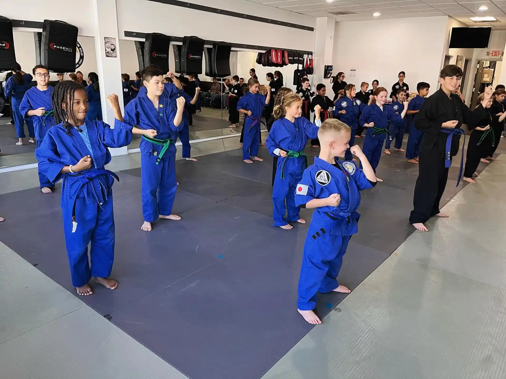 a group of children in blue karate uniforms