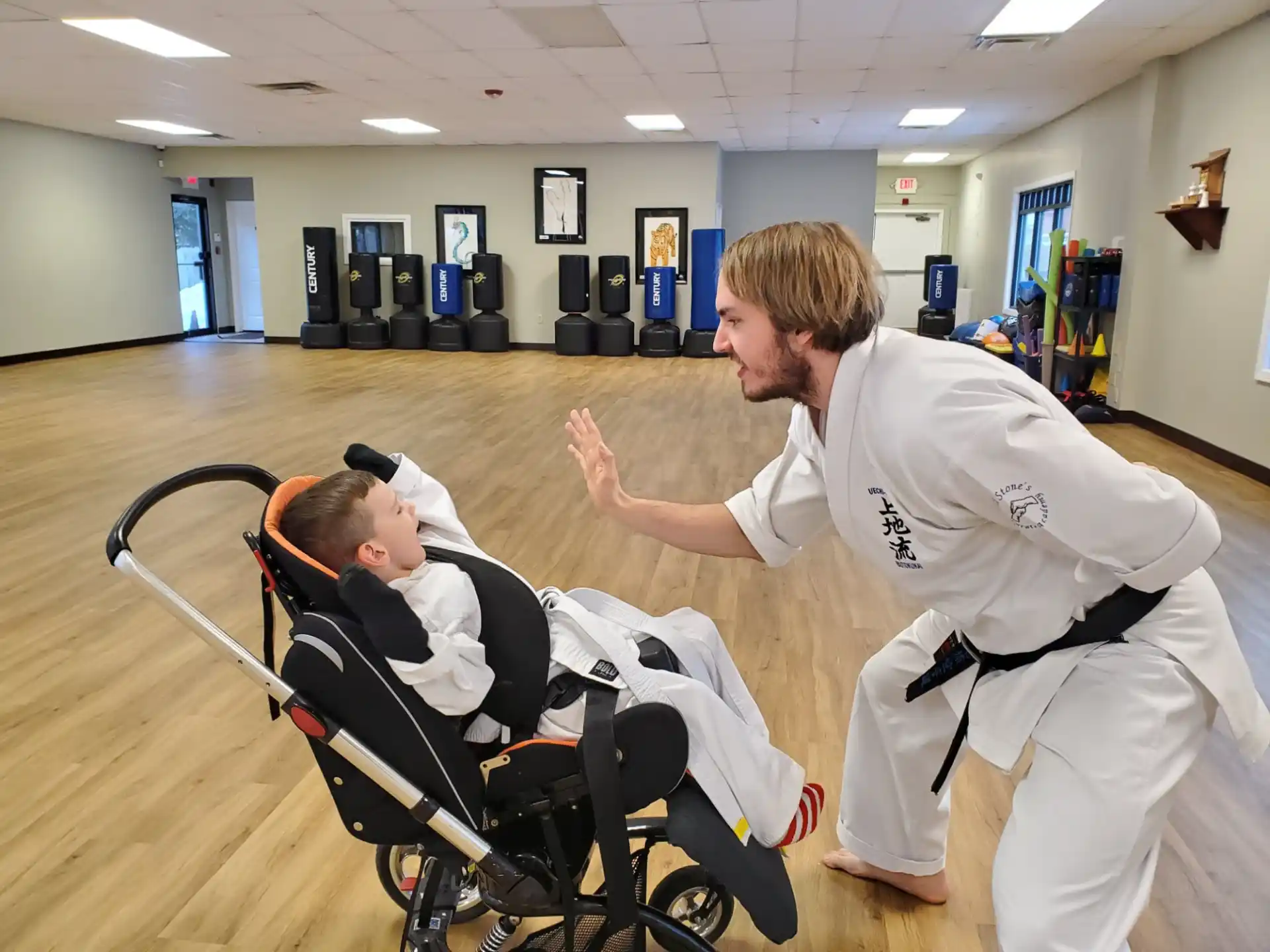 a man in a white uniform with a man in a wheelchair