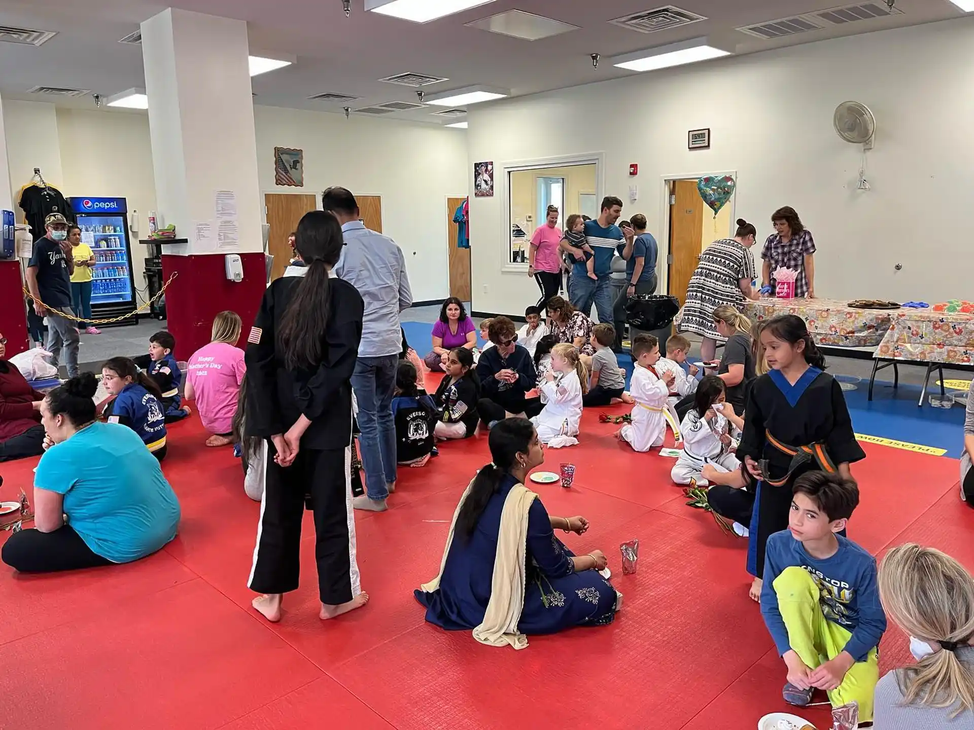 a group of people sitting on the floor in a room