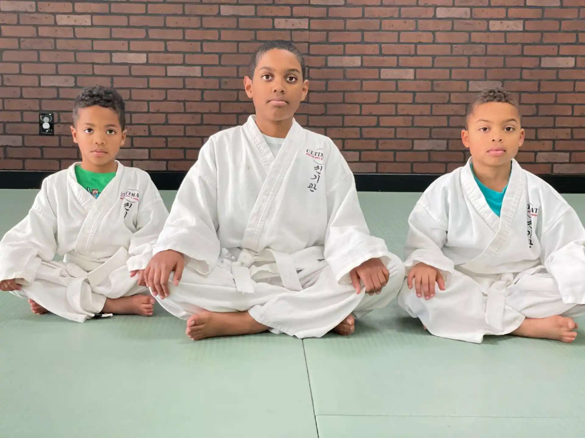 a group of boys in karate uniforms