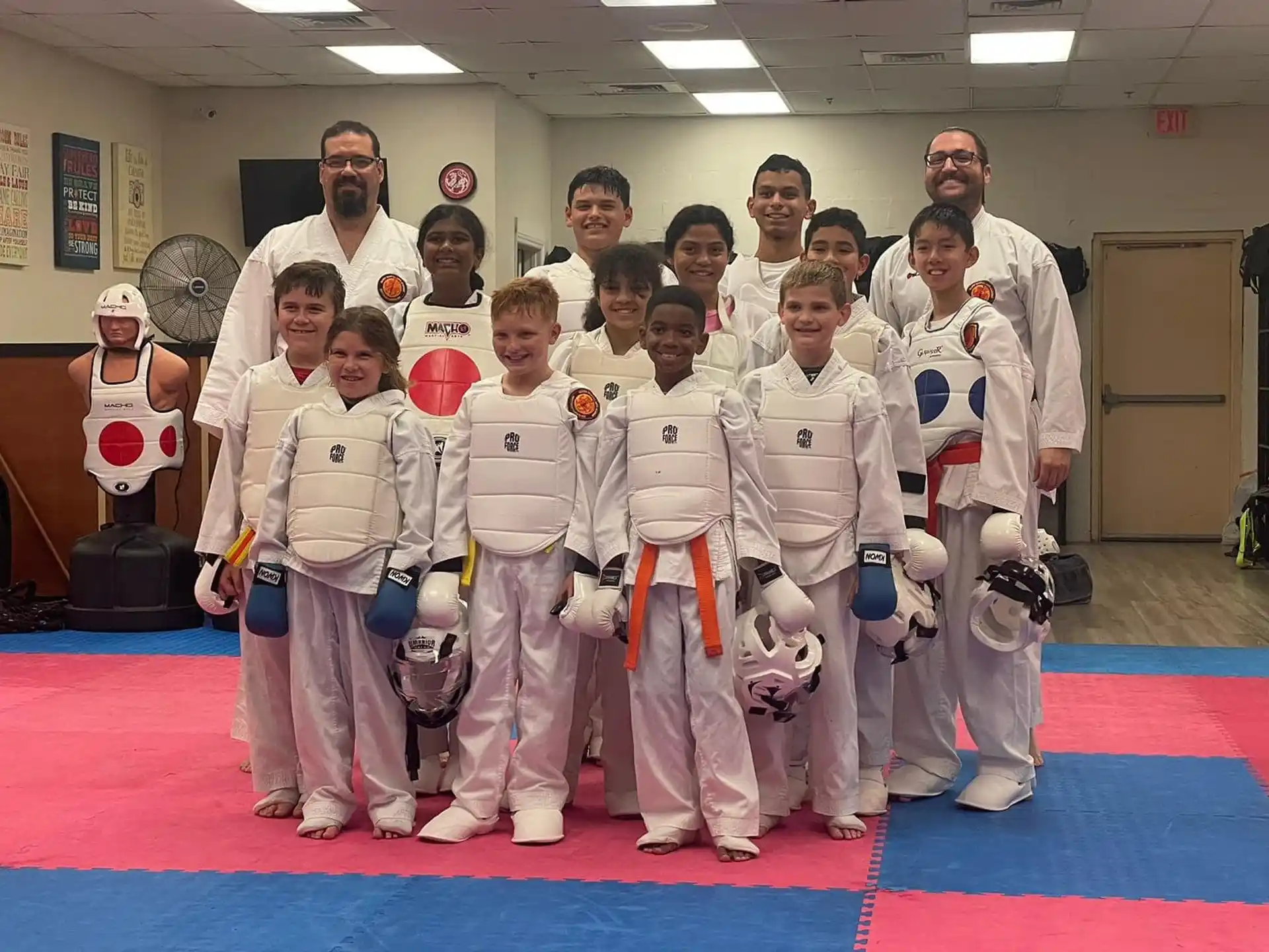 a group of people in white karate uniforms