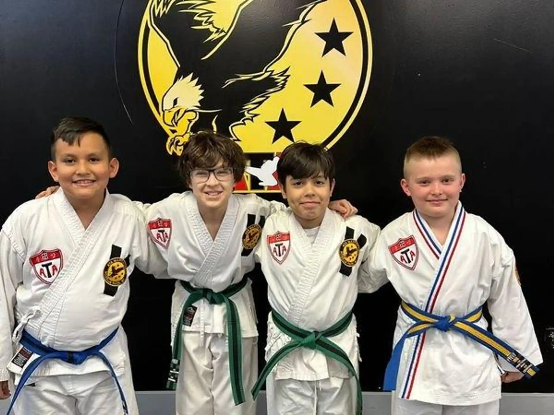 a group of boys in karate uniforms
