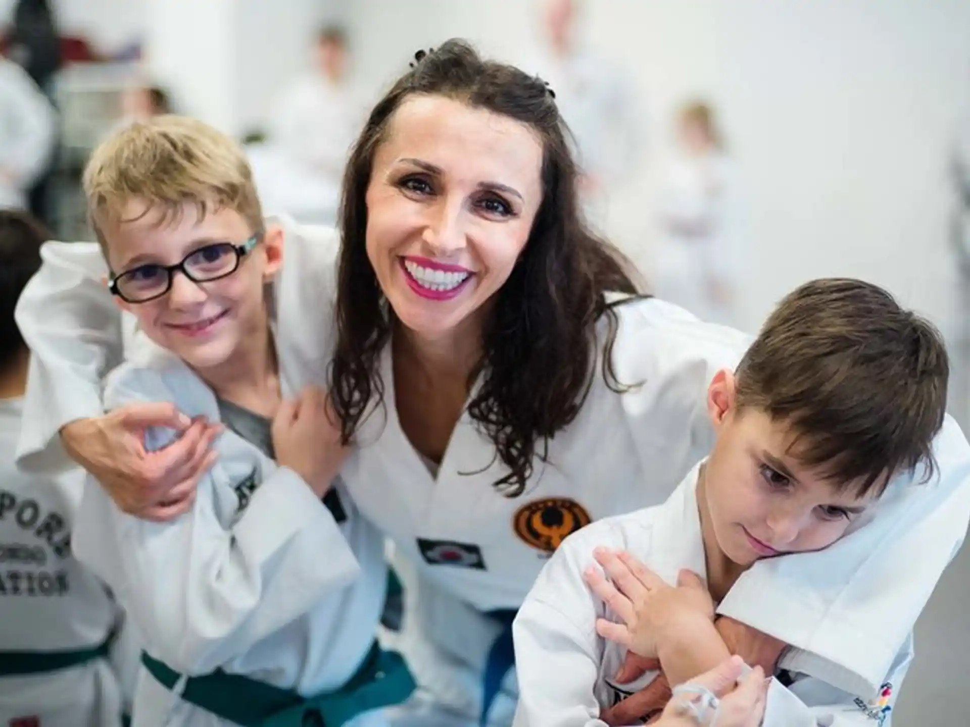 a person and several children in white lab coats