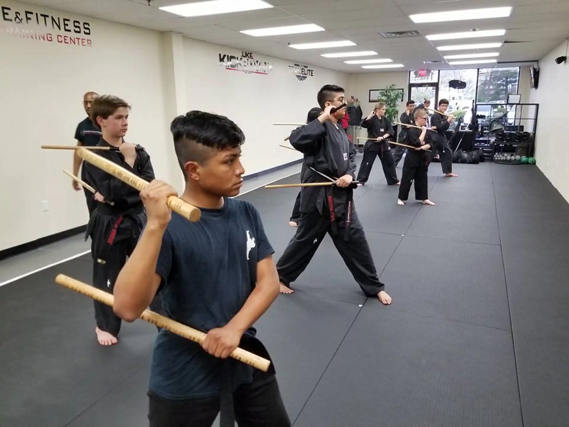 a group of people holding brooms